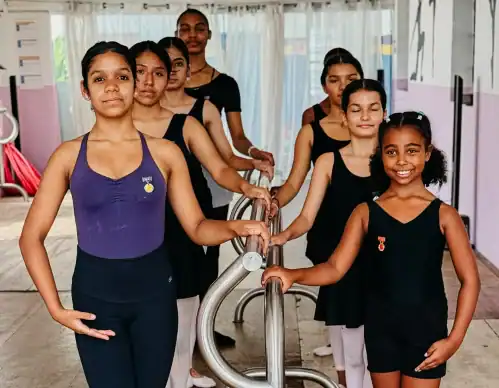 Aula de ballet infantil no Instituto Sonhe com crianças praticando dança escolar.